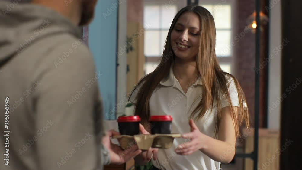 delivery, mail and people concept - happy man delivering coffee and food in disposable paper bag to customer home and taking payment. delivery, mail and people concept - happy man delivering coffee and food in disposable paper bag to customer home and taking payment.