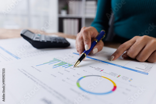 Business financing accounting banking concept. Business woman hand doing finances and calculate on desk about cost at home office. Woman working on desk with using calculator, finance accounting. 