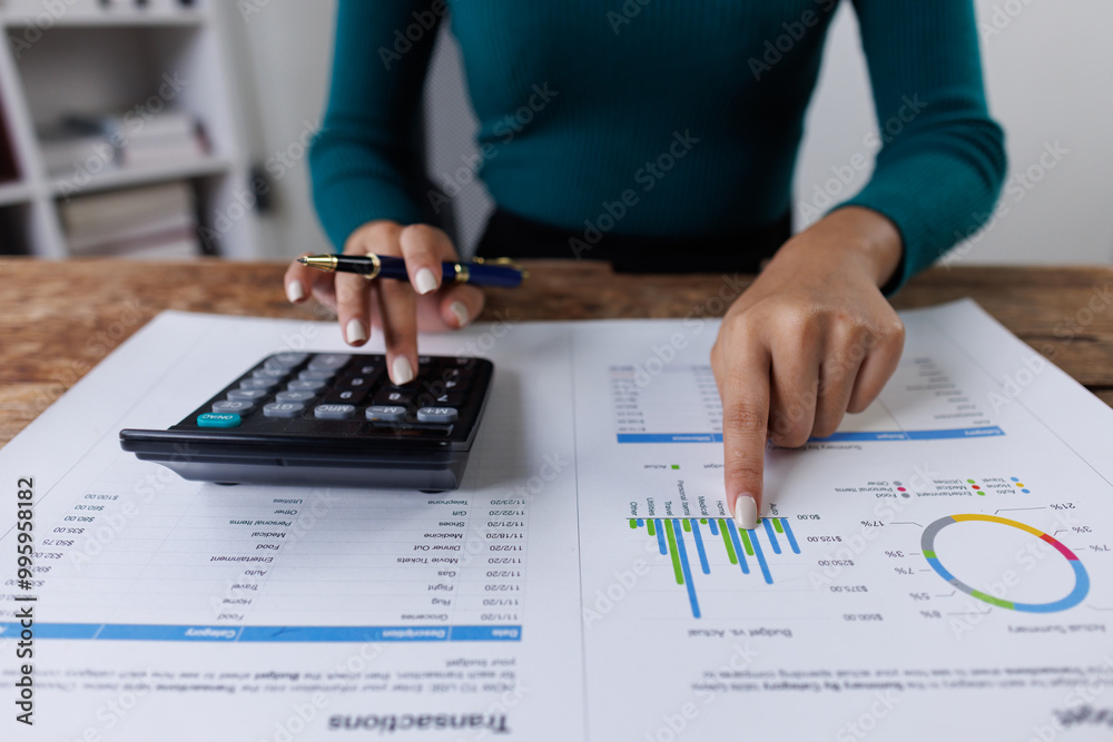 Business financing accounting banking concept. Business woman hand doing finances and calculate on desk about cost at home office. Woman working on desk with using calculator, finance accounting.
Business financing accounting banking concept. Business woman hand doing finances and calculate on desk about cost at home office. Woman working on desk with using calculator, finance accounting.