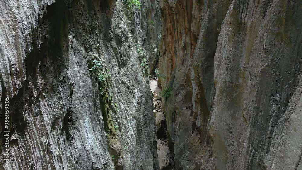 Drone is flying in between massive cliffs, mountains surrounding a path, 4k Drone is flying in between massive cliffs, mountains surrounding a path, 4k