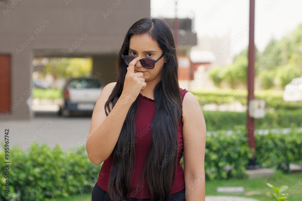 Indian Woman Looking Up from Sunglasses Indian Woman Looking Up from Sunglasses
