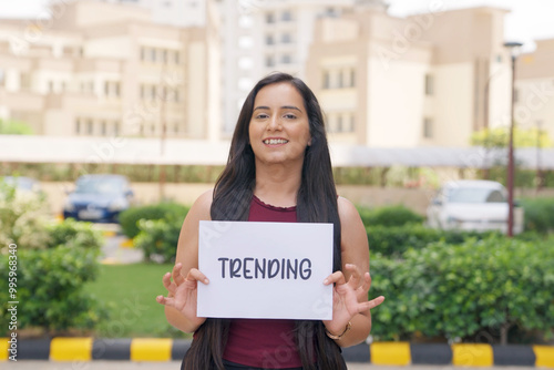 Indian Woman standing with Trending Poster