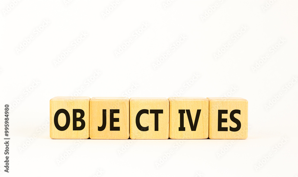 Objectives symbol. Concept word Objectives on beautiful wooden blocks. Beautiful white background. Business objectives concept. Copy space.