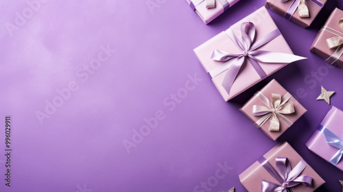 Top view of gifts, bows and Christmas decorations on a purple background