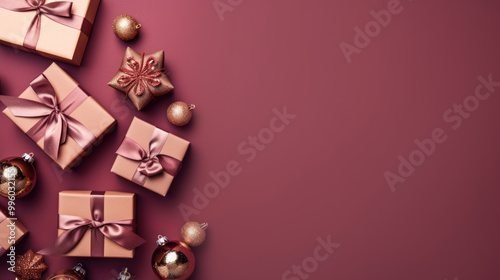 Top view of gifts, bows and Christmas decorations on a light maroon background