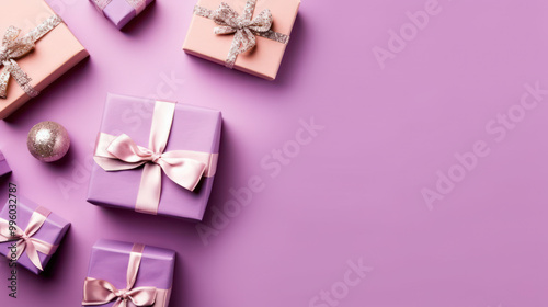 Top view of gifts, bows and Christmas decorations on a light magenta background