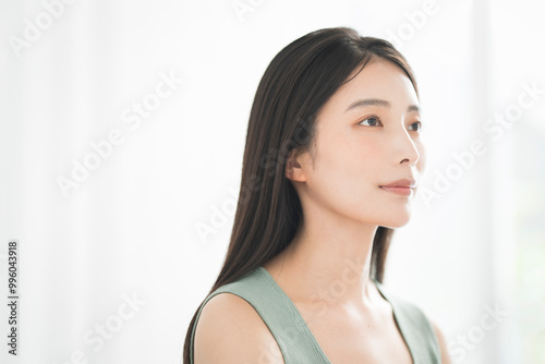 Portrait of a young beautiful Asian woman. She has straight black hair.