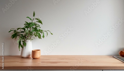 Kitchen wooden countertop on white wall background. Minimalistic room with tabletop and plant in vase for product presentation. Clean closeup mockup. interior of a room with a plant