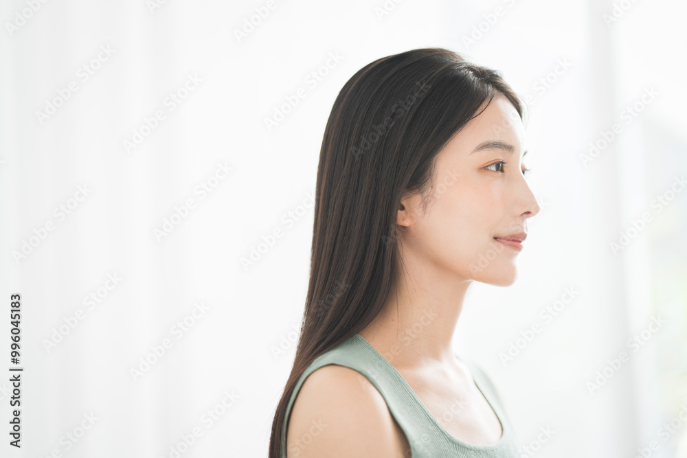 Portrait of a young beautiful Asian woman. She has straight black hair. Portrait of a young beautiful Asian woman. She has straight black hair.