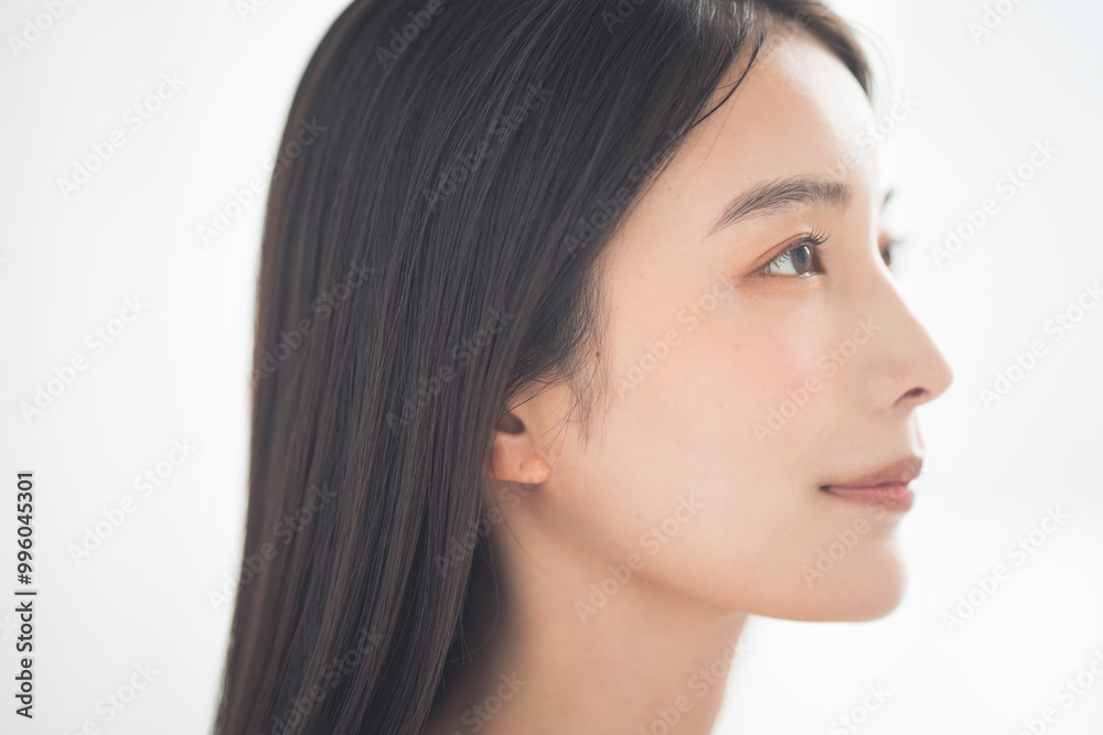 Portrait of a young beautiful Asian woman. She has straight black hair. Portrait of a young beautiful Asian woman. She has straight black hair.