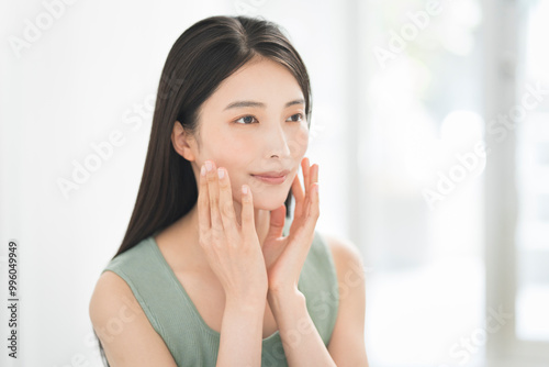 Skin care. Woman with beauty face touching healthy facial skin portrait. Asian woman. 