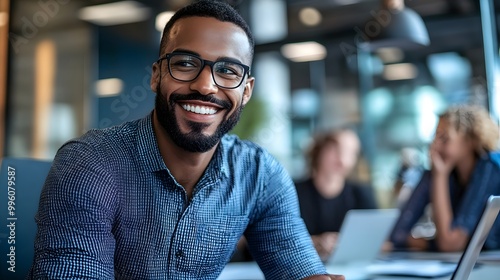 Smiling Man Wearing Glasses in Office Setting