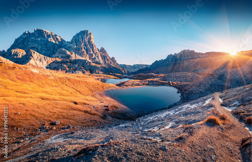 Schusterplatte peak hangs over the surface of the Piani lake. Stunning autumn view of Dolomite alps. Gorgeous sunrise in Tre Cime Di Laveredo National Park, Italy. photo