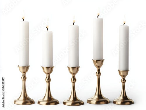 A set of brass candlesticks holding tall white candles, flickering softly in the evening isolated on white background.