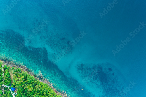 Exotic idyllic sea rocky island turquoise sea bay with green tree forest photo