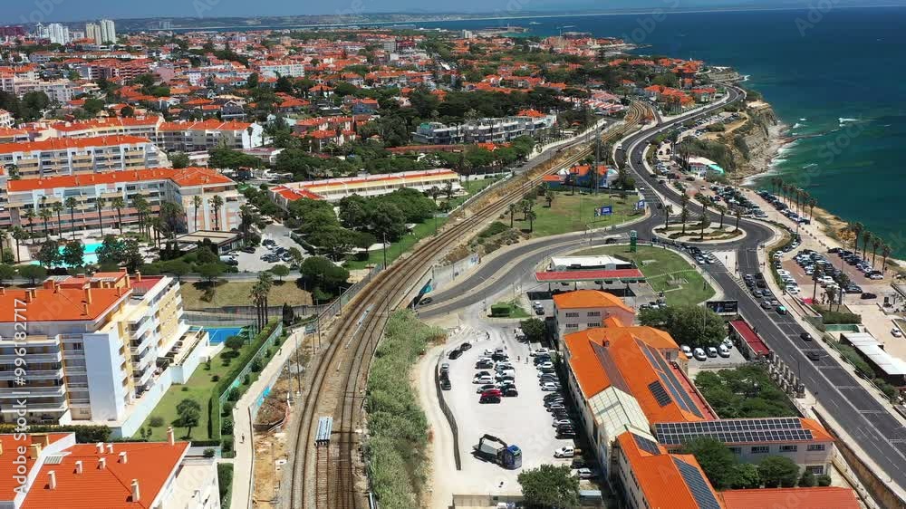 From above drone view of crowded cityscape by Sao Pedro do Estoril beach during sunny day. Aerial shot of buildings on coastal area in Lisbon, Portugal. From above drone view of crowded cityscape by Sao Pedro do Estoril beach during sunny day. Aerial shot of buildings on coastal area in Lisbon, Portugal.