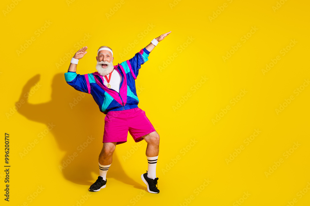 Full body photo banner of funny senior sportsman dance golden medal dressed stylish retro sport costume isolated on yellow color background Full body photo banner of funny senior sportsman dance golden medal dressed stylish retro sport costume isolated on yellow color background