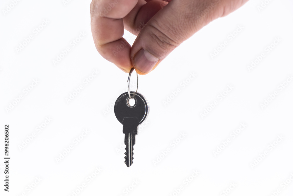 Hand holding house key on white background. Hand holding house key on white background.