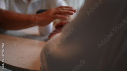 Wallpaper Mural Close-up cropped shot of unrecognizable happy senior couple sharing warm conversation over coffee, holding hands intertwined, radiating love and companionship in cozy cafe. Concept of active aging. Torontodigital.ca