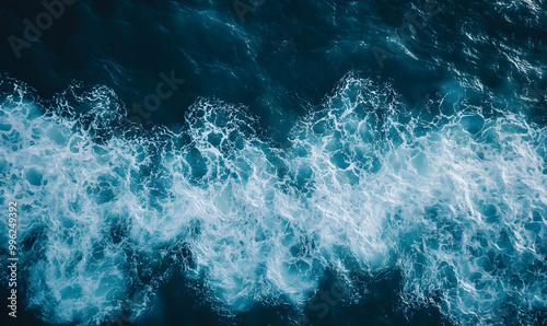 Top view of sea wave with foam splashing on beach with sand