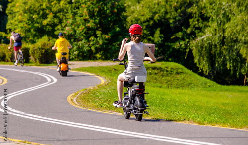 Wallpaper Mural A woman rolls on an electric scooter in the Park
 Torontodigital.ca