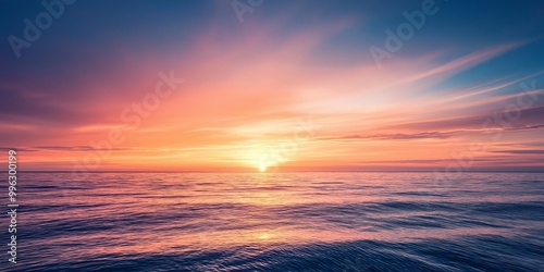 Fototapeta Naklejka Na Ścianę i Meble -  A breathtaking sunset with vibrant colors painted across the sky reflecting on the serene and expansive ocean waters.
