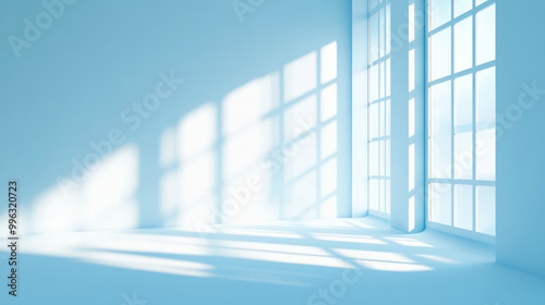 A minimalistic abstract light blue background, perfect for product presentations. Soft shadows and light from windows create a subtle effect on the wall, adding depth and dimension to the scene. The c