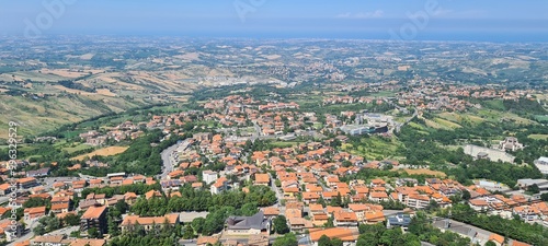 Summer view from San Marino to Italy. June 28, 2024. Italy landscape around San Marino - hills, houses, roofs, nature.