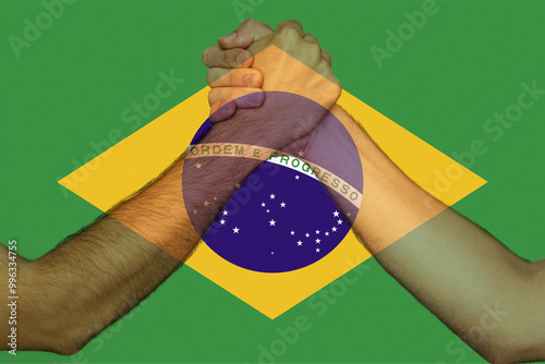Two hands gathering front of Brazil flag, human rights, union of society, togetherness and 