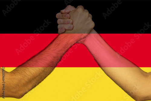 Two hands gathering front of Germany flag, union of society, human rights, help or support for 