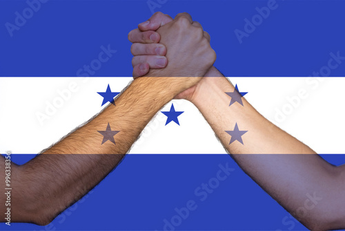 Two hands gathering front of Honduras flag, togetherness and solidarity concept, human rights