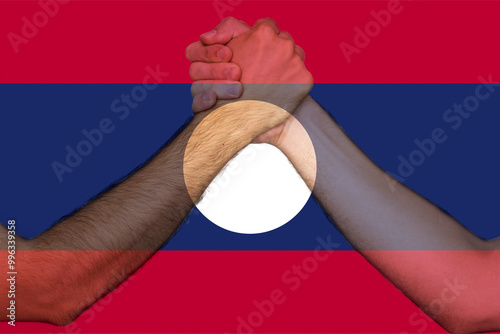 Two hands gathering front of Laos flag, union of society, human rights, help or support for Laos