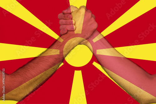 Two hands gathering front of Macedonia flag, togetherness and solidarity concept, human rights
