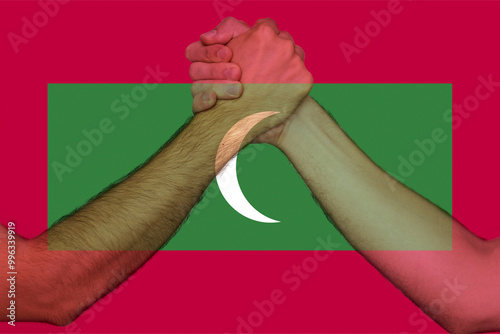 Two hands gathering front of Maldives flag, human rights, togetherness and solidarity concept