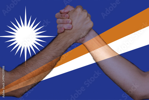Two hands gathering front of Marshall Islands flag, togetherness and solidarity concept, union 