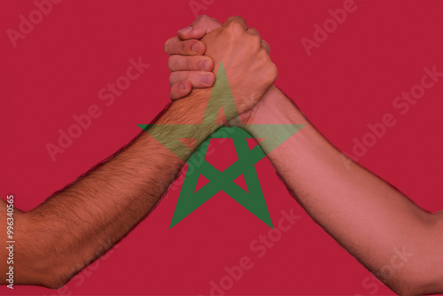 Two hands gathering front of Morocco flag, togetherness and solidarity concept, human rights, help 