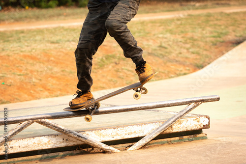 Skateboarder performing the nosegrind maneuver photo