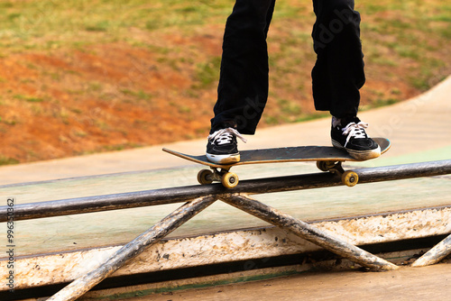 Skateboarder performing the fifty maneuver. photo