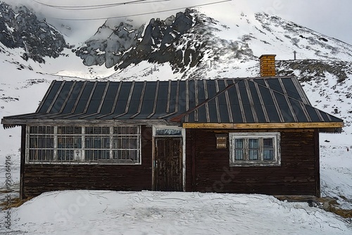 Partly dinged cottage in the mountains photo