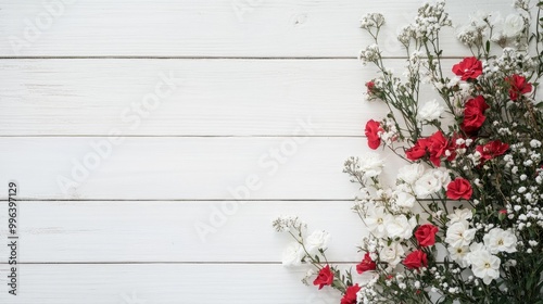 Fresh flowers positioned in the lower right corner against a white wooden background displaying a minimalistic aesthetic and providing ample space for text within a realistic setting