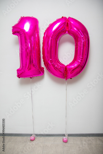 pink number 10 balloons on white background