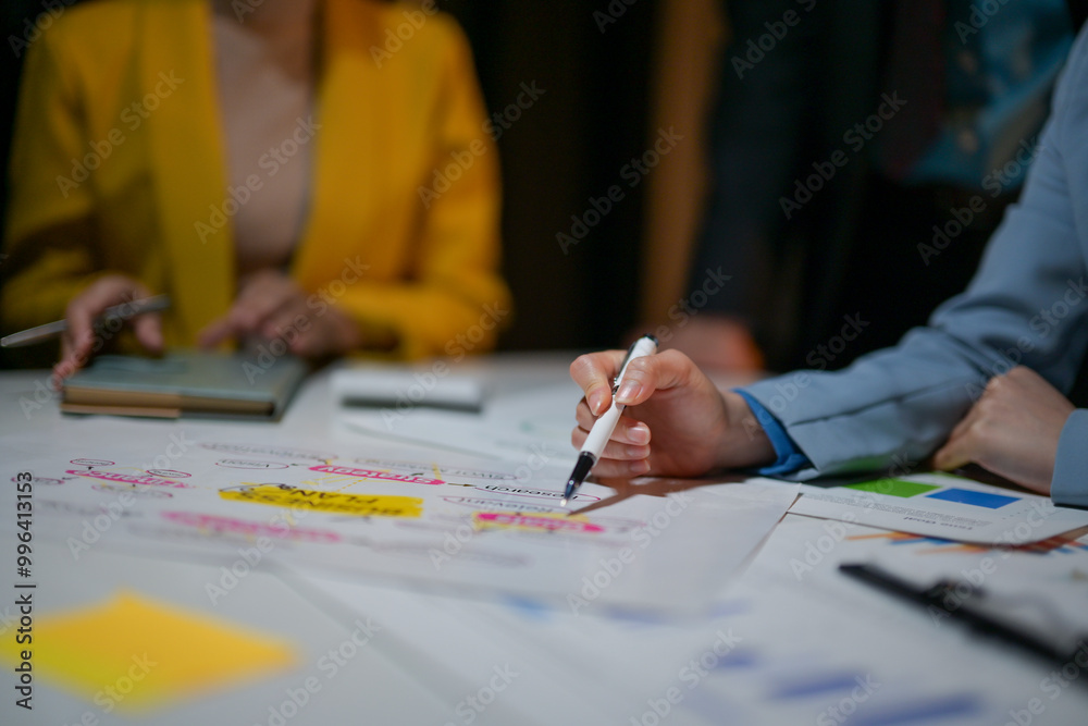 A woman is writing on a white board with a pen A woman is writing on a white board with a pen