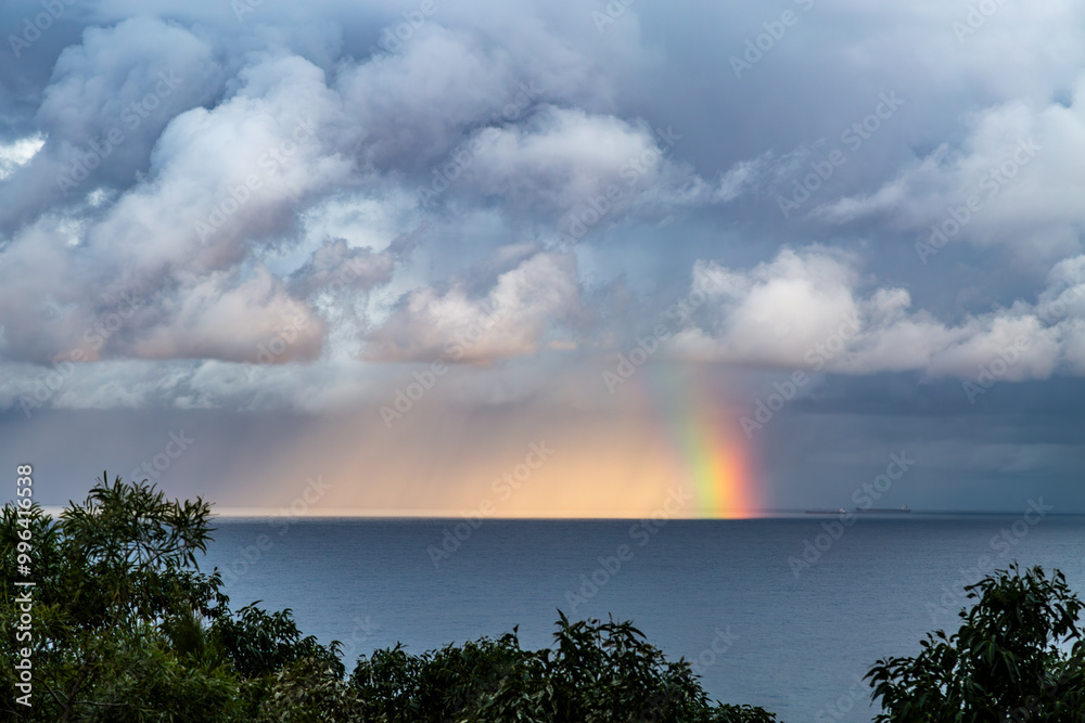 Rain storm and rainbow off Wollongong on the Illawarra Coast, NSW. Rain storm and rainbow off Wollongong on the Illawarra Coast, NSW.