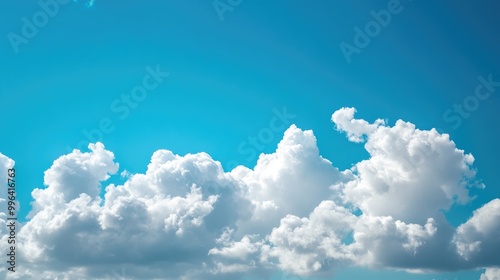 Clear blue sky featuring fluffy white clouds ideal for a backdrop with ample copy space photo