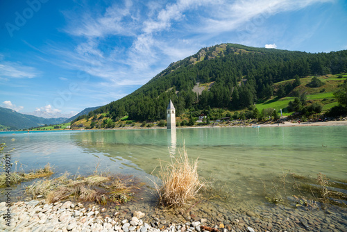 View of Lake Resia where you can admire the famous bell tower of photo