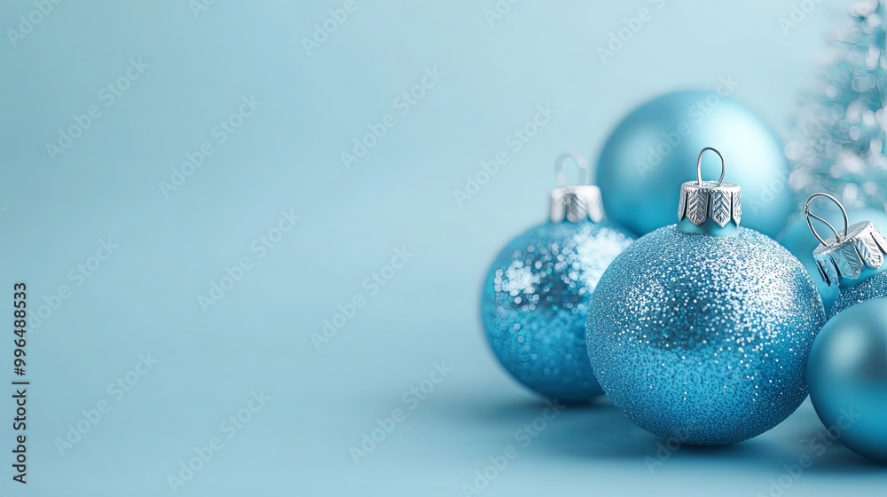 Sparkling Blue Christmas Ornaments on a Light Blue Background Sparkling Blue Christmas Ornaments on a Light Blue Background