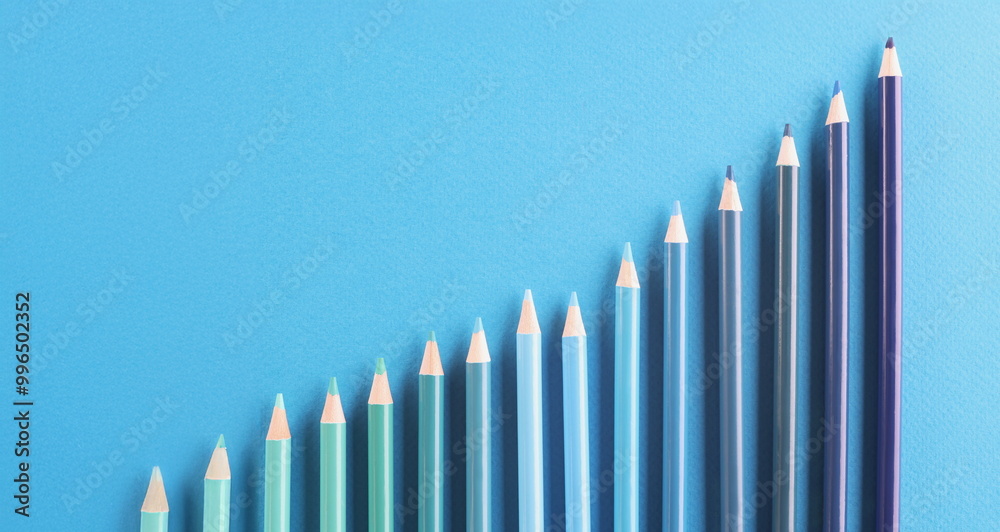 Top view of blue colored pencil set arranged in increasing way on surface and not exactly in row. Tool for draw your dreams, ideas and vision. Art concept Top view of blue colored pencil set arranged in increasing way on surface and not exactly in row. Tool for draw your dreams, ideas and vision. Art concept