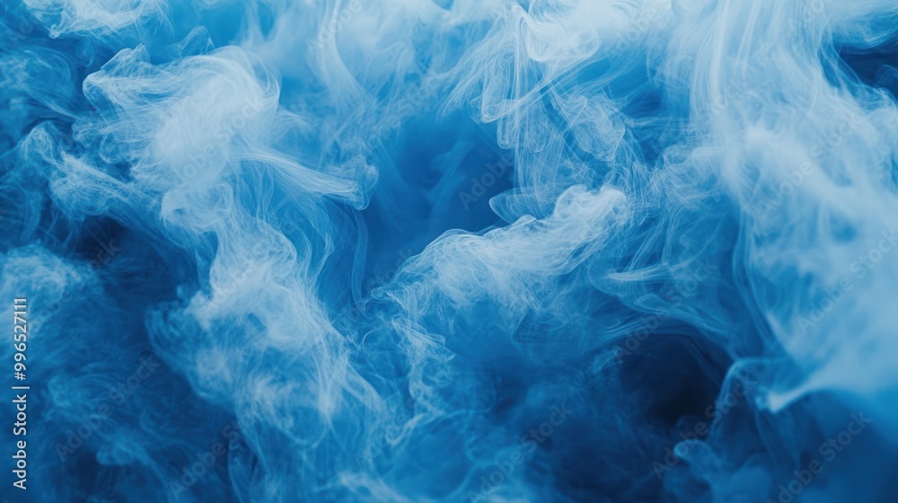 Obraz premium Beautiful swirling blue smoke creating an ethereal and calming abstract background.