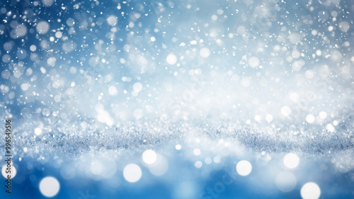 Blurred christmas background. Snow and snowflakes on blue with light bokeh.