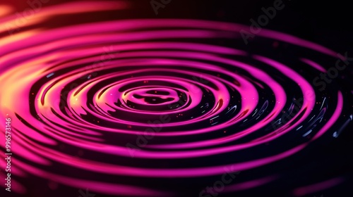 Colorful water ripples creating vibrant patterns on a dark background.